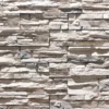 Flexible stone veneer in a light gray tone, featuring a rugged, textured ledgestone pattern perfect for an eye-catching interior wall or exterior facade.