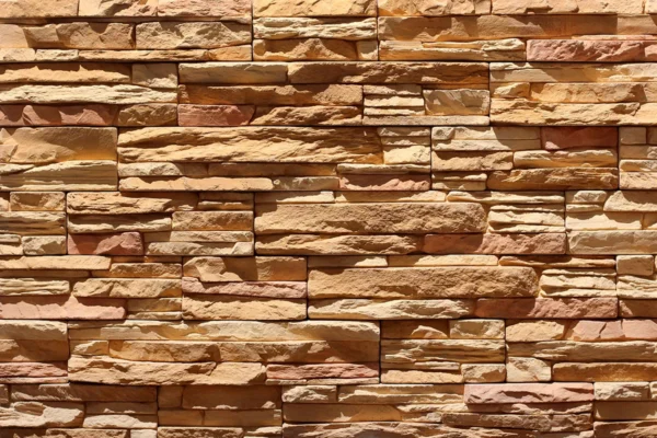 Ledge Stone 9 Flexible stone veneer in warm, earthy tones and rugged texture, perfect for adding a natural, cliff-like aesthetic to any interior wall or exterior facade.