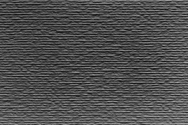 Cut Stone 2 Elevate your space with our cut stone flexible tile, featuring a dark, textured pattern ideal for modern interior walls or exterior facade cladding.