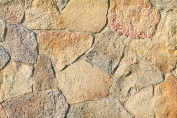 Field Stone 1 Achieve a rustic aesthetic with this flexible stone veneer, showcasing a multi-toned color palette and natural texture, ideal for interior walls and exterior facades.