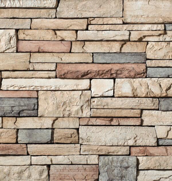 Flexible stone veneer in Mojave color with a country ledgestone pattern offers a textured finish suitable for interior wall and exterior facade applications.