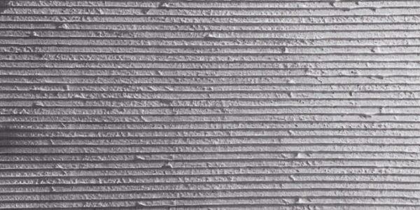 Flexible stone veneer featuring a linear pattern in a light gray shade, ideal for a modern interior wall or unique exterior facade. Contact us today!