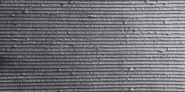 Square Line Stone flexible veneer in dark gray with a horizontal striped texture, ideal for modern interior wall cladding or exterior facade design.