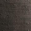 Flexible stone veneer in dark gray with horizontal ribbed texture, ideal for modern interior wall cladding or exterior facade with lightweight design.