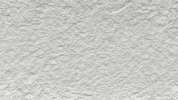 Flexible stone veneer in a light gray hue with a textured surface, ideal for modern interior wall and exterior facade applications.