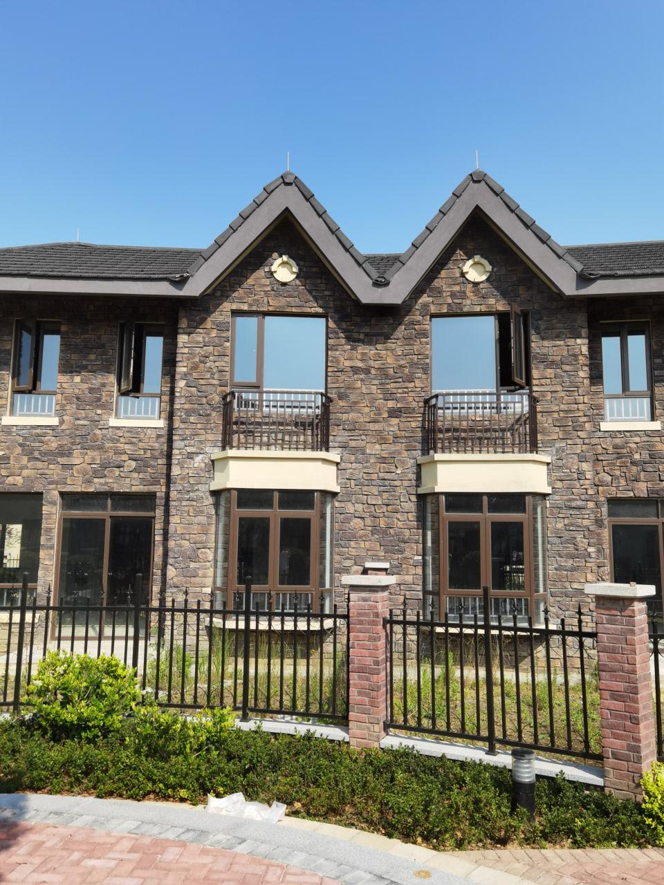 House exterior with natural stone-look flexible tiles
